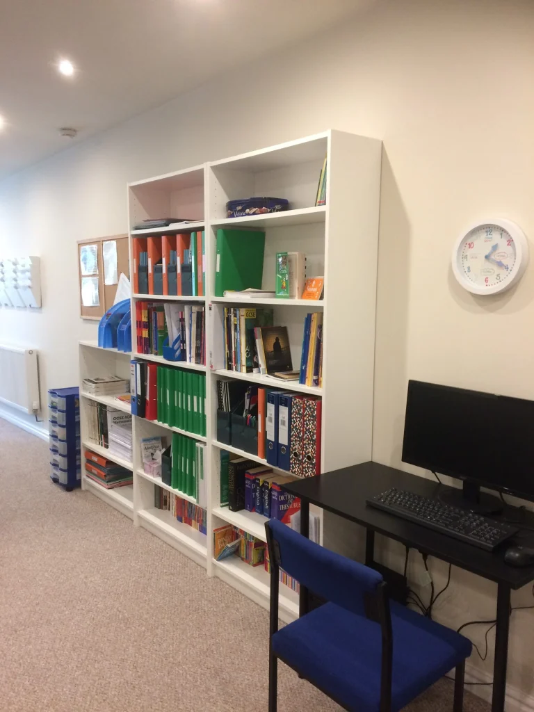 Study area with bookshelves of resources and a computer desk