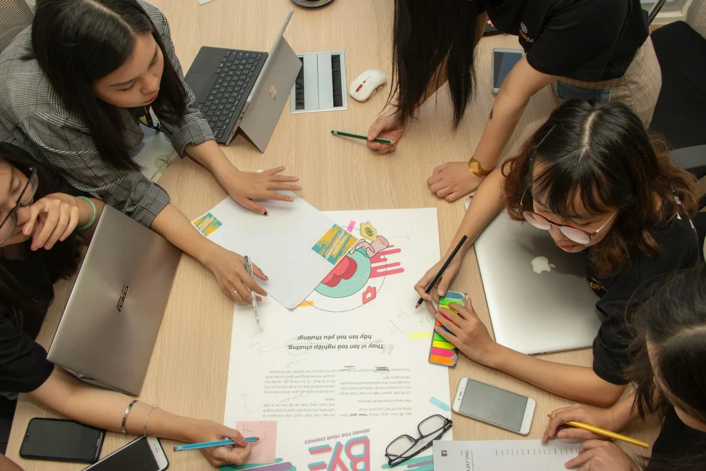 Group of students working together on a poster