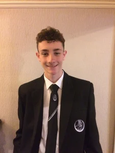 Past student Sam in his school uniform