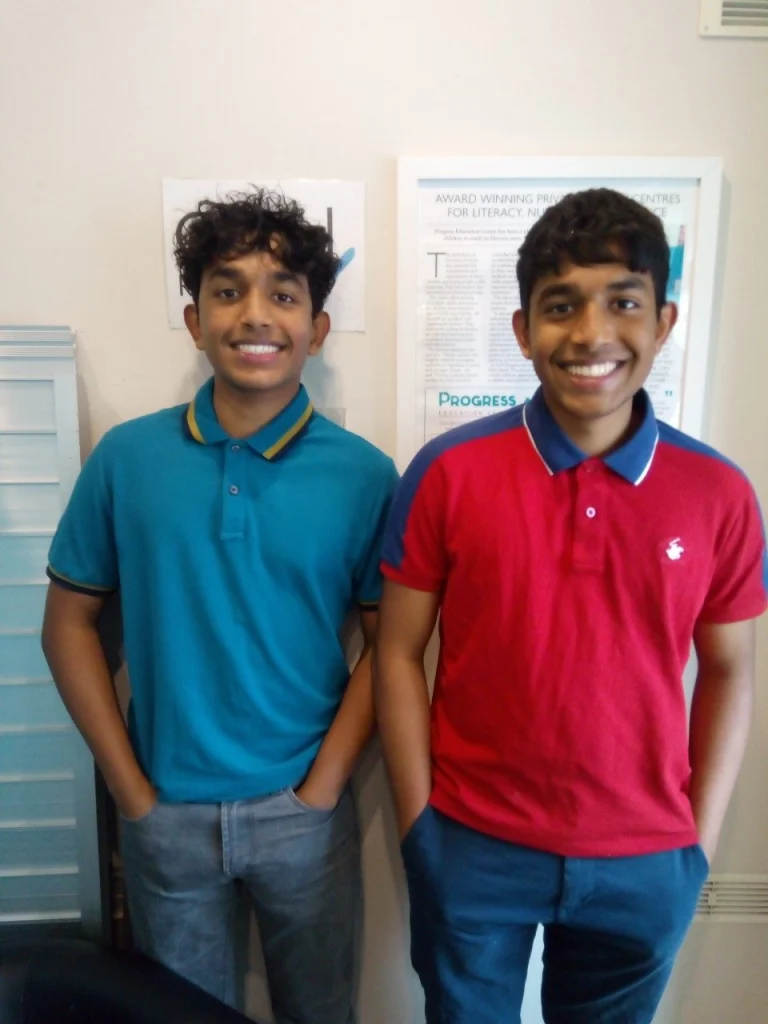 Two former students, Josh and John, standing together at the centre