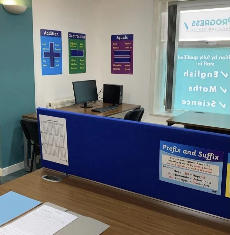 Haslingden centre classroom with desks, computers and literacy and maths posters