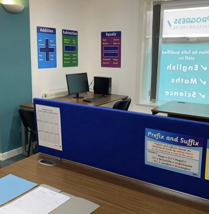 Haslingden centre classroom with desks, computers and literacy and maths posters