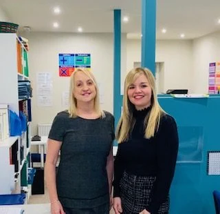 Two tutors standing together inside the Haslingden centre